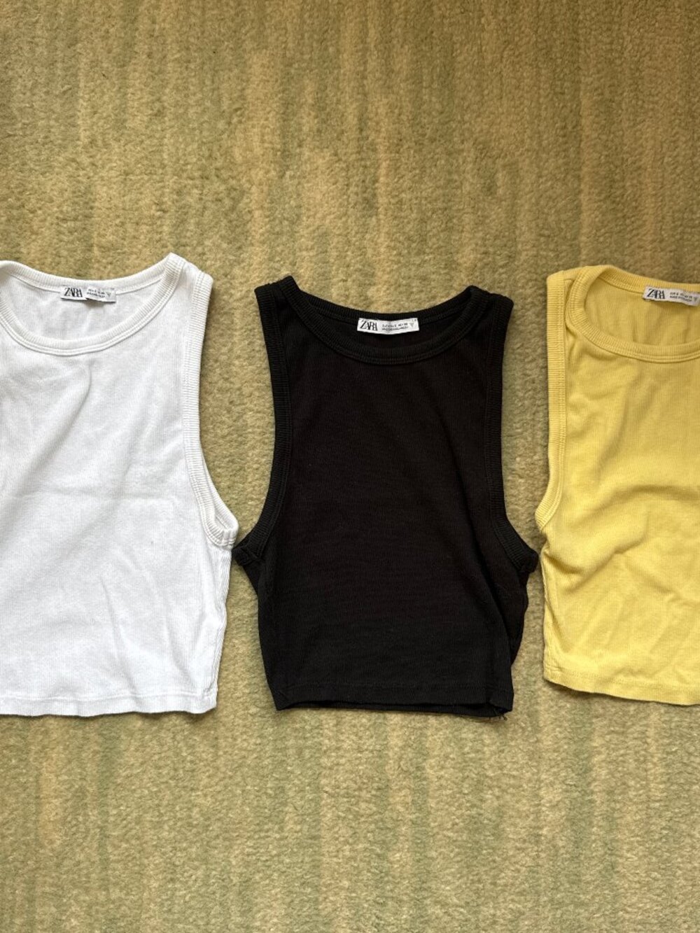 White, black, and yellow tank tops